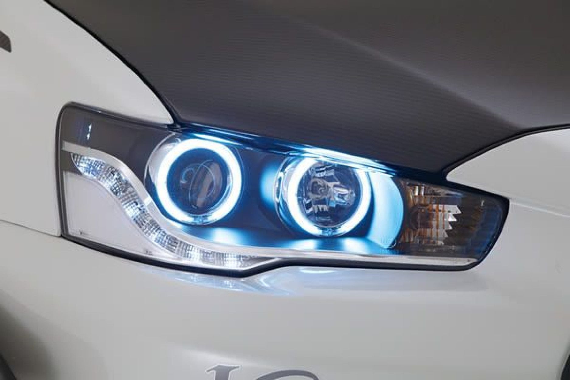 Mitsubishi lancer фары. Фары Mitsubishi Lancer 10 Angel Eyes. Фары Mitsubishi Lancer 10. Оптика на Мицубиси Лансер 10. Передние фары Lancer 10.